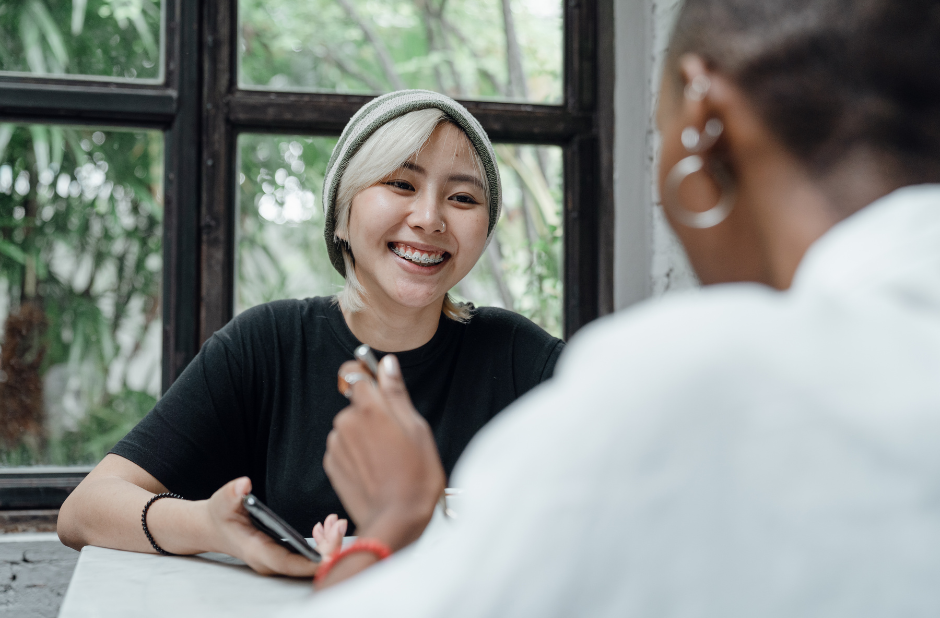 An asian woman talking to a Afro-American woman