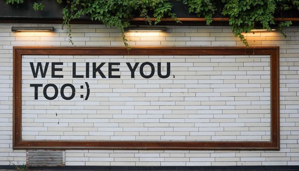 We like you too :) Written in capital letters on a wall.