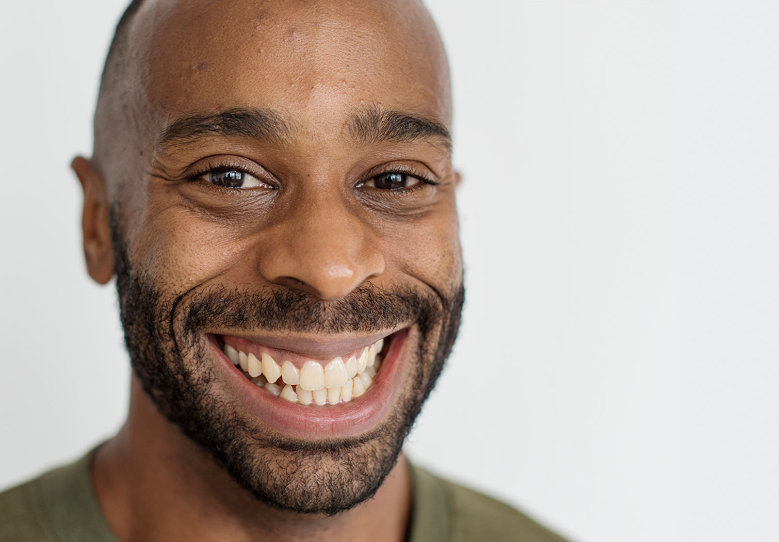 A in a green t-shirt man smiling